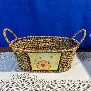 Woven basket with a metal picture of honeybees and flowers. 10.5L, 7”W, 4”D